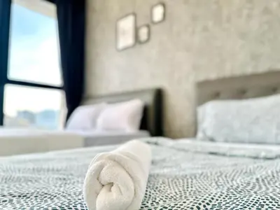 a towel laying on a bed in a bedroom at View of Whole Georgetown Sea&City View 3BR-12 a27 in Jelutong
