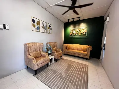 a living room with two chairs and a ceiling fan at D'Farah Homestay Teluk Intan 3Bilik in Teluk Intan