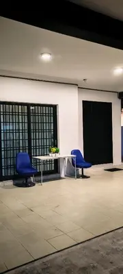 two blue chairs and a table in a room at 23 Inn Queenbed Room with share bathroom in Simpang Ampat