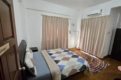 a bedroom with a bed with a quilt on it at Near USM 6 pax, 2 Bedroom w Aircond, 2 toilet, 5G WIFI in Si Dua Besar