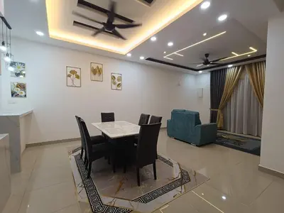 a dining room with a table and chairs at Homestay Coway Bertam in Kampong Sungai Korok