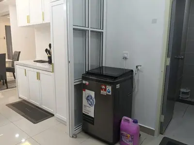 a kitchen with a trash can in a room at Homestay Coway Bertam in Kampong Sungai Korok