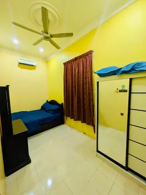 a bedroom with a bed and a ceiling fan at Seri Changkat Homestay in Kampong Changkat Raja