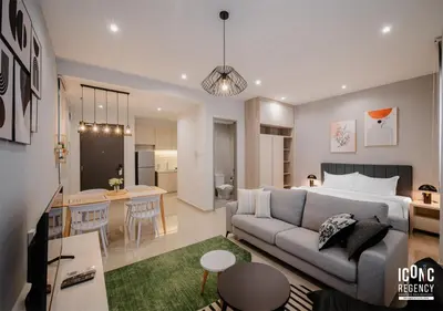 a living room with a couch and a living room and a kitchen at Iconic Regency Service Residences, managed by Iconic Hotel in Bayan Lepas