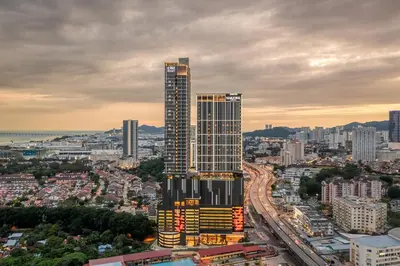 a tall skyscraper in the middle of a city at Iconic Regency Service Residences, managed by Iconic Hotel in Bayan Lepas