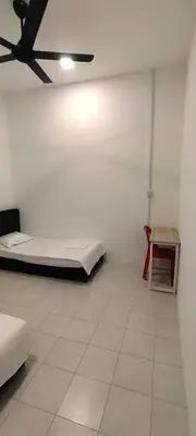 a room with two beds and a ceiling fan at Homestay Bandar Puteri Jaya in Sungai Petani