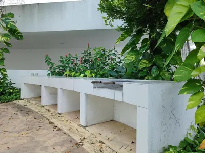 a white bench with plants on top of it at Seaview Vacation Condo 3R3B 8Pax in Kampong Batu Maung