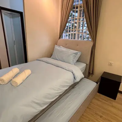 a bedroom with a bed with two pillows and a window at Cozy Corner Home Alma Near AEON \u5927\u5c71\u811a\u6e29\u99a8\u6c11\u5bbf in Bukit Mertajam