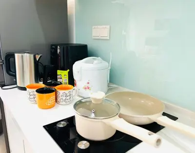 a kitchen counter with a bowl on top of a stove at Mansion One l 4pax Studio l MountainView & CityView l Gleneagles l by PerfectSweetHome in George Town