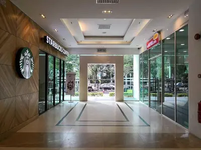 a lobby of a building with a clock on the wall at Mansion One l 4pax Studio l MountainView & CityView l Gleneagles l by PerfectSweetHome in George Town