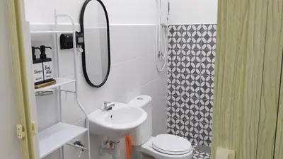 a bathroom with a sink and a toilet and a mirror at IFS Seri Iskandar by Glex in Seri Iskandar