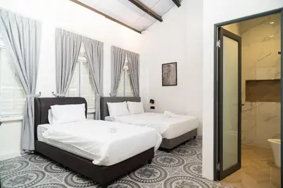 two beds in a room with a mirror at Jovial Industrial Stylish Lodge ````Bukit Mertajam in Bukit Mertajam