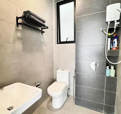 a bathroom with a toilet and a sink at Georgetown Childroom Seaview & Cityview Infinity Pool with 2 Carpark in Jelutong