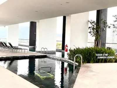 a swimming pool in the middle of a building at Georgetown Childroom Seaview & Cityview Infinity Pool with 2 Carpark in Jelutong