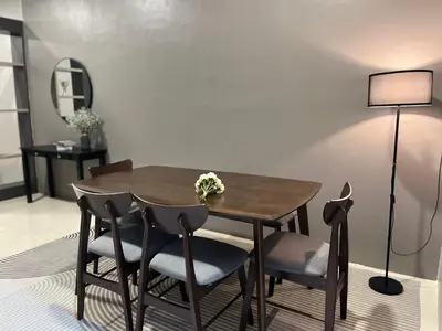 a dining room with a wooden table and chairs at AbelHome in Teluk Intan