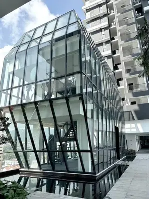 a glass building in front of a tall building at Urban Seaview with Infinity Pool, Luxury Modern Stylish 7pax 3Bedroom 3Queen in Jelutong