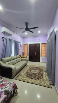 a living room with a couch and a ceiling fan at Sekinchan Homestay Teratak AZ - muslm only in Kampong Batu Dua Puloh Tiga