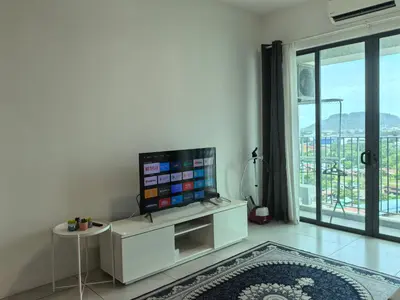 a living room with a flat screen tv on a white cabinet at Meritus Comfy 3 Bedroom with 8 Pax in Jalan Baharu
