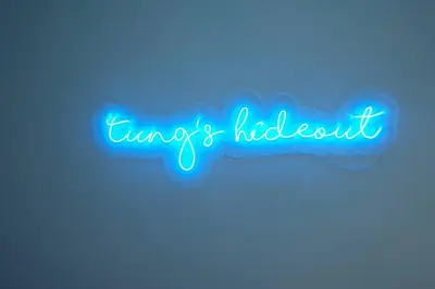 a neon sign that reads envy and helpless at Tung's Hideout- Centrum Cameron in Brinchang