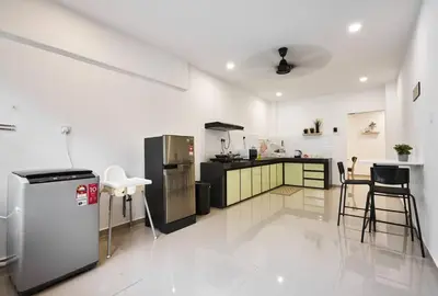 a kitchen with black and white appliances in a room at Ipoh South Homestay 8-16pax 10mins to attraction in Ipoh