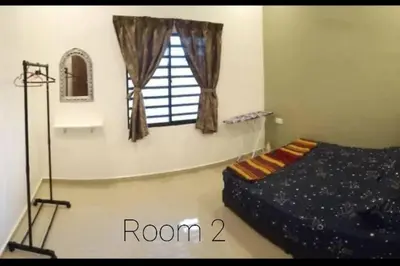 a bedroom with a bed and a window at Ipoh Buntong Corner homestay in Ipoh
