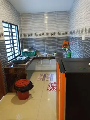 a kitchen with a sink and a counter top at Ipoh Buntong Corner homestay in Ipoh