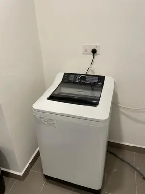 a white stove top oven sitting next to a wall at Jazz Service Suite in Bagan Jermal