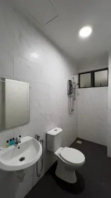 a white bathroom with a toilet and a sink at O Homestay Meru Ipoh at Casa Kayangan - Musleem in Bandar Meru Raya