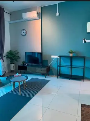 a living room with a table and a tv at O Homestay Meru Ipoh at Casa Kayangan - Musleem in Bandar Meru Raya