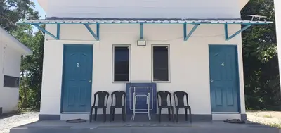 a group of chairs sitting outside of a house at Chalet Meroloh Kuala Kangsar in Kuala Kangsar