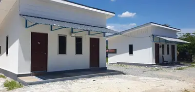 a small white building with two doors on it at Chalet Meroloh Kuala Kangsar in Kuala Kangsar