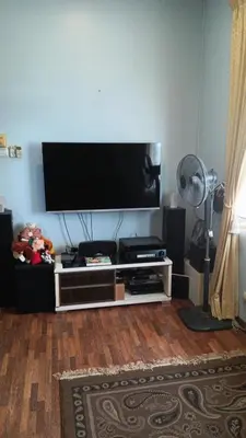 a living room with a flat screen tv on a wall at Will Ma in Ayer Itam