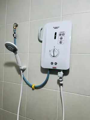 a soap dispenser on a wall in a bathroom at Khasif Amani Homestay Parit Buntar in Parit Buntar