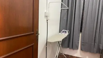 a chair in a room next to a door at Homestay Rumah 25 in Sungai Petani