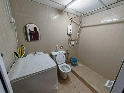 a bathroom with a toilet and a sink and a mirror at Bayu Emas Batu Ferringhi 2 in Ayer Itam