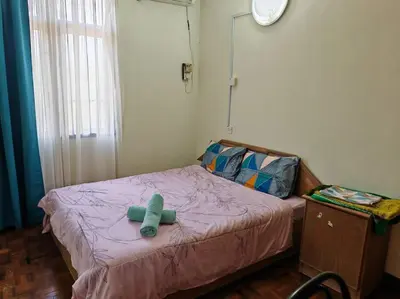 a small bed with a green teddy bear on it at Bayu Emas Batu Ferringhi 2 in Ayer Itam