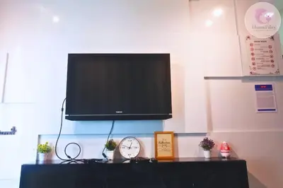 a flat screen tv hanging on a wall with a clock at The Majestic Condo Ipoh Home Fairy 3 in Ipoh