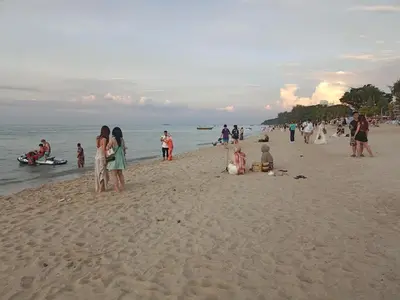 a group of people standing on a beach at Sri sayang pearl view in Batu Ferringhi