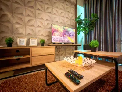 a living room with a tv and a coffee table at Ipoh Majestic 2 Bedrooms 4Pax Modern Apartment by City Home Empire in Ipoh