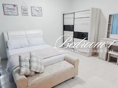a white bedroom with a bed and a couch at Guest House Iman Umi Bagan Serai in Bagan Serai