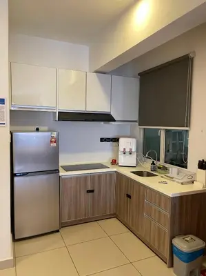 a kitchen with wooden cabinets and a stainless steel refrigerator at JS Ipoh Homestay 2 At The Majestic Ipoh in Ipoh
