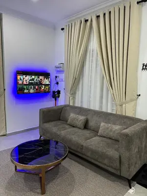 a living room with a couch and a coffee table at Idaman Cottage Sekinchan in Tanjung Karang