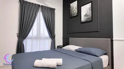 a bedroom with a bed with two towels on it at The Horizon Ipoh by 40 Winks in Ipoh