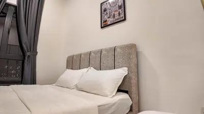 a bedroom with a bed with white sheets and pillows at The Horizon Ipoh by 40 Winks in Ipoh