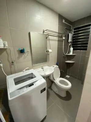 a bathroom with a sink and a toilet and a mirror at L26 happy homestay in Kampong Sungai Udang