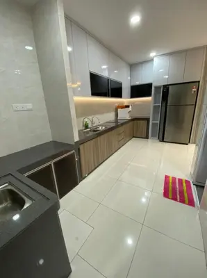 a large kitchen with a sink and a refrigerator at L26 happy homestay in Kampong Sungai Udang