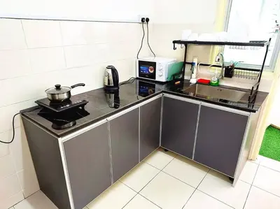 a kitchen with a counter with a pot on a stove at Tur -Weeks Stay-3rooms Private House in Bayan Lepas