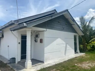 a small white building with a blue roof at Pintu A Damai D'Sawah in Kampong Parit Fourteen