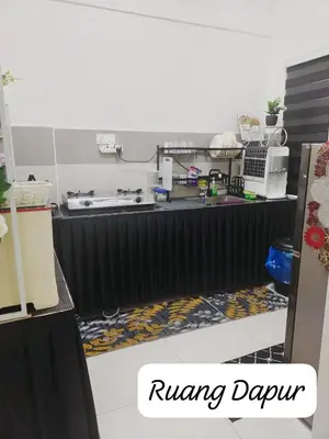 a kitchen with a table with a sink and a counter top at Meeymohd Homestay in Ipoh