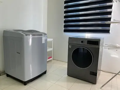 a dryer and a washing machine in a room at Deandra Homestay- WiFi-Aircond-Dryer in Sungai Petani